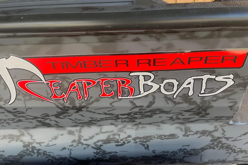 Slide: The Image of 2026 Reaper Boats 553 Timber Reaper logo on a textured surface. - 5
