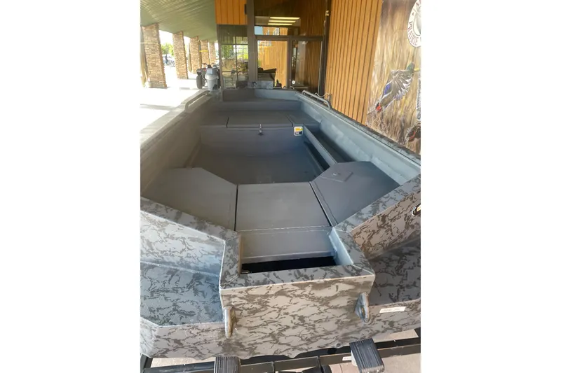 Slide: The Image of 2026 Reaper Boats 553 Timber Reaper with camouflage design, displayed outdoors. - 9