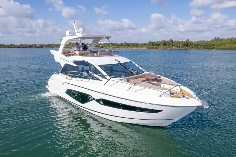 The Image of 2018 Sunseeker Manhattan 52 yacht cruising on a serene blue waterway. - 0