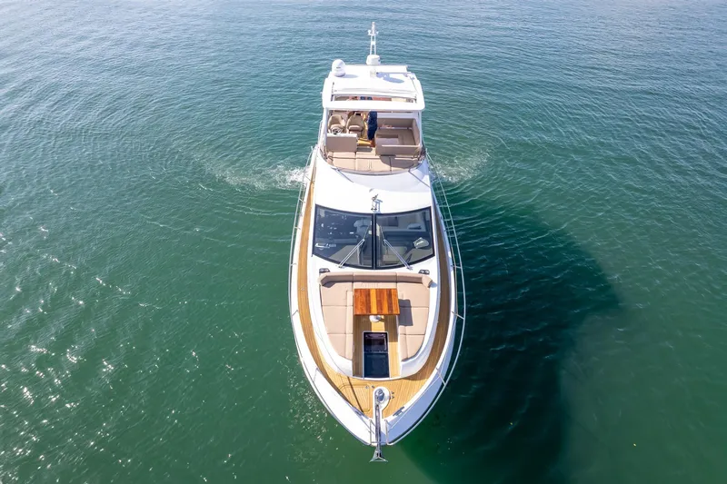 Slide: The Image of 2018 Sunseeker Manhattan 52 yacht cruising on open water, aerial view. - 13