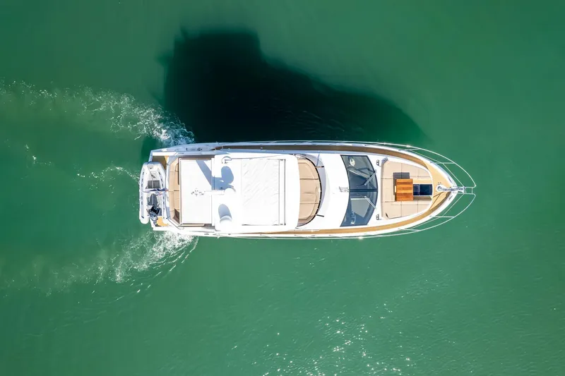 Slide: The Image of Aerial view of 2018 Sunseeker Manhattan 52 yacht cruising on green water. - 15