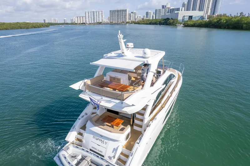 Slide: The Image of 2018 Sunseeker Manhattan 52 yacht cruising near city skyline. - 16