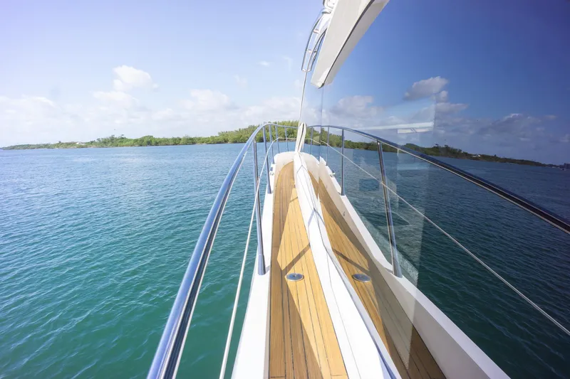 Slide: The Image of 2018 Sunseeker Manhattan 52 yacht cruising on clear blue waters under a sunny sky. - 18