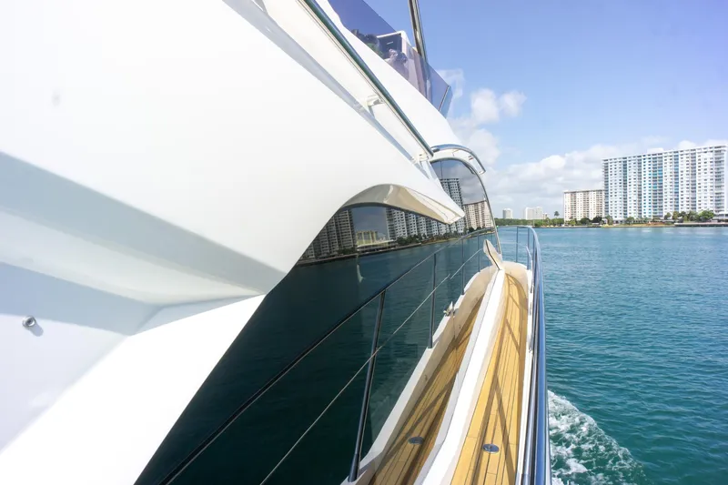 Slide: The Image of 2018 Sunseeker Manhattan 52 yacht cruising near coastal buildings on a sunny day. - 19