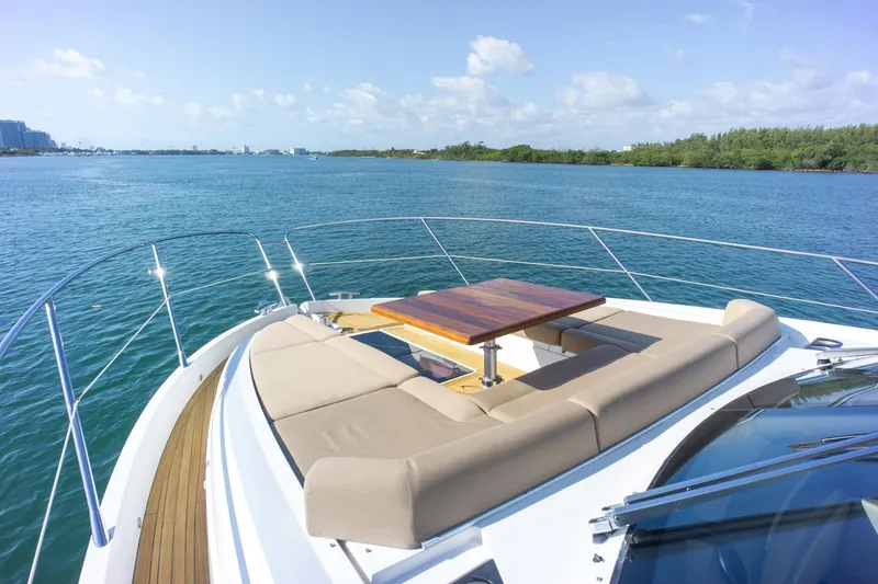 Slide: The Image of Luxurious 2018 Sunseeker Manhattan 52 yacht with elegant deck seating and scenic water view. - 22