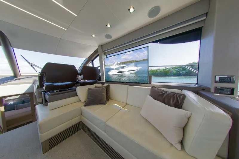 Slide: The Image of Luxurious interior of 2018 Sunseeker Manhattan 52 yacht with plush seating and scenic window view. - 38