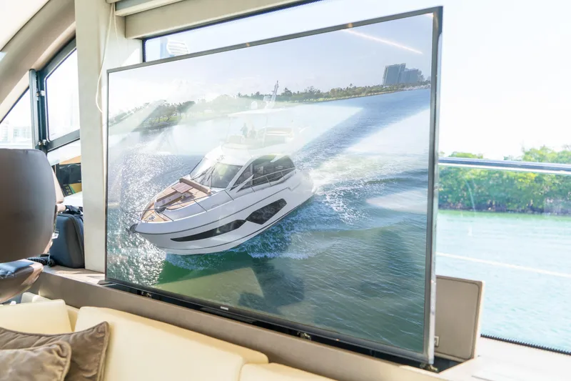Slide: The Image of Interior view of a Sunseeker Manhattan 52 yacht, showcasing a large TV screen. - 61