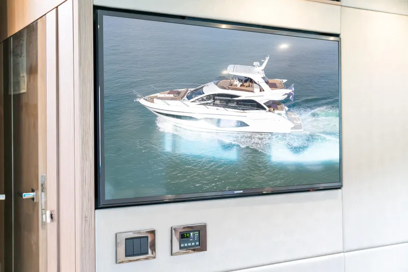 Slide: The Image of 2018 Sunseeker Manhattan 52 yacht displayed on a wall-mounted screen. - 62