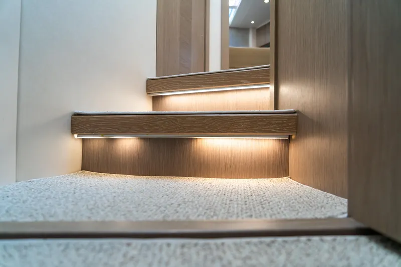 Slide: The Image of Staircase with ambient lighting on 2018 Sunseeker Manhattan 52 yacht interior. - 64