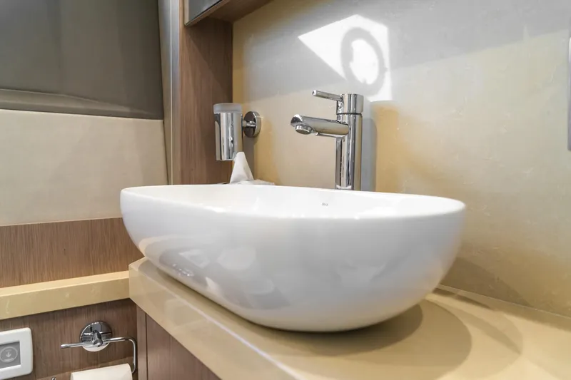 Slide: The Image of Modern bathroom sink on 2018 Sunseeker Manhattan 52 yacht, featuring sleek design and chrome fixtures. - 66