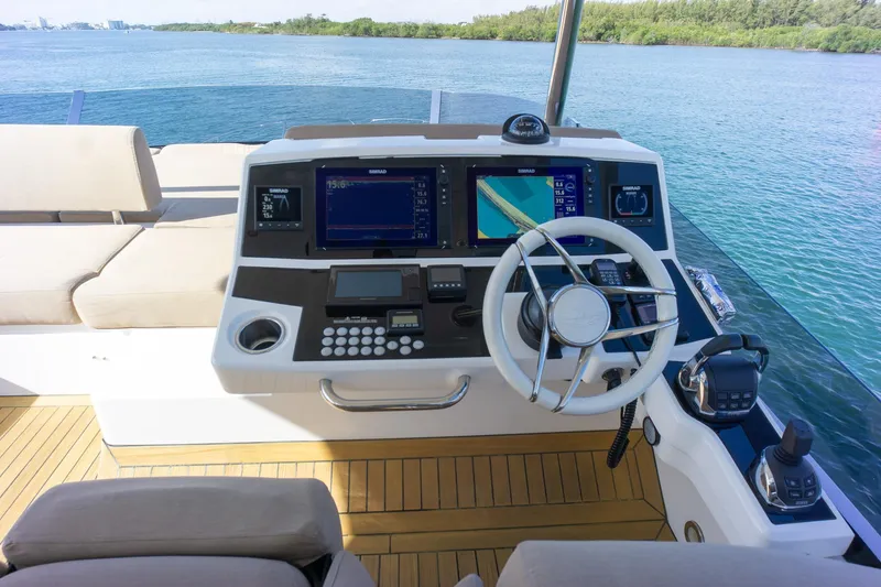 Slide: The Image of Helm of 2018 Sunseeker Manhattan 52 yacht with navigation screens and steering wheel. - 73