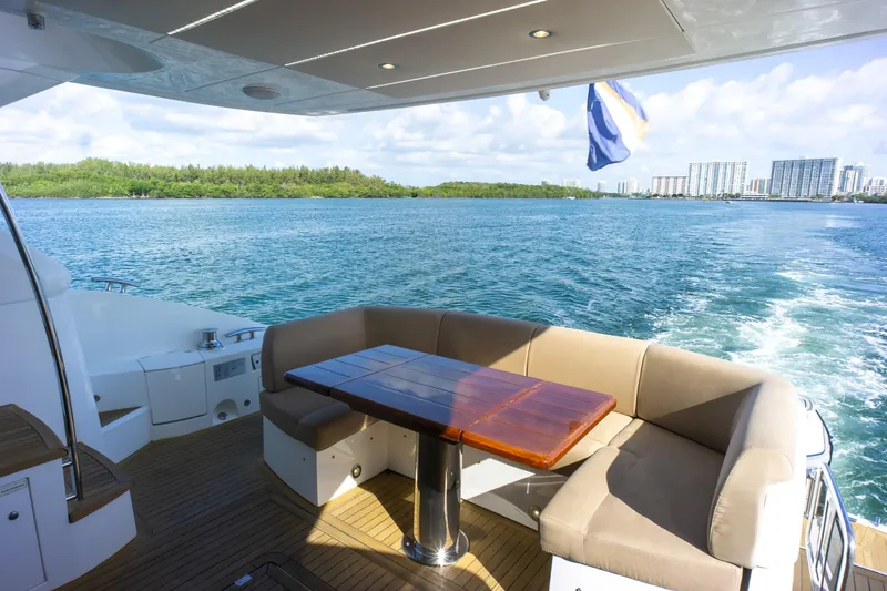 Slide: The Image of Luxury Sunseeker Manhattan 52 yacht deck with seating, cruising on blue waters, 2018 model. - 74