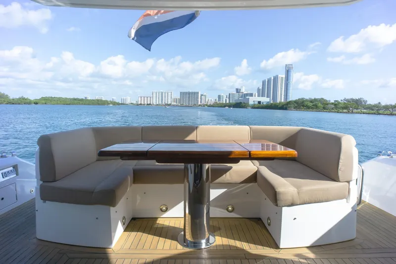 Slide: The Image of Luxurious Sunseeker Manhattan 52 yacht deck with seating, overlooking city skyline and water. - 75