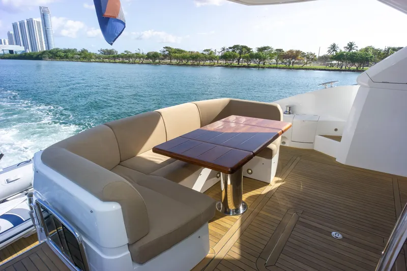 Slide: The Image of Luxurious Sunseeker Manhattan 52 yacht deck with seating and table, 2018 model. - 76