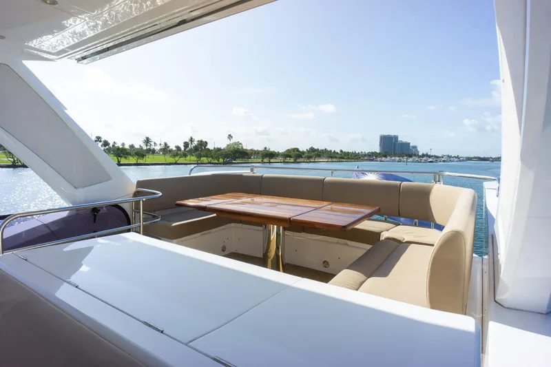 Slide: The Image of Luxurious Sunseeker Manhattan 52 yacht deck with elegant seating and scenic waterfront view. - 79