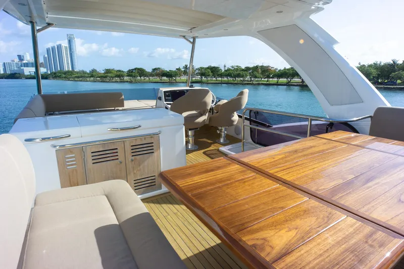 Slide: The Image of Luxurious 2018 Sunseeker Manhattan 52 yacht interior with elegant seating and scenic waterfront view. - 80