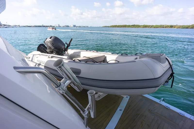 Slide: The Image of Inflatable boat on 2018 Sunseeker Manhattan 52 yacht, docked on calm blue waters. - 82