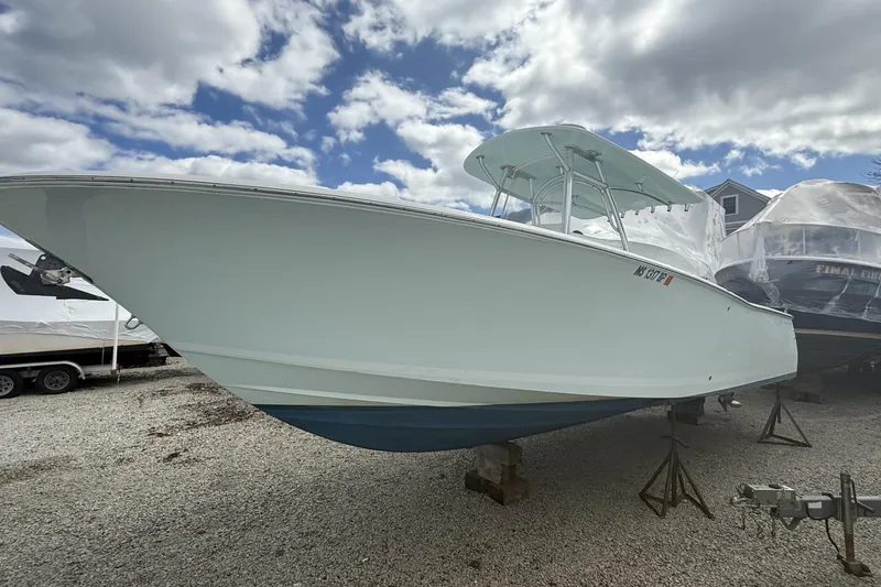 Slide: The Image of 2012 Southport 29 Tournament Edition boat on stands, under cloudy sky. - 24