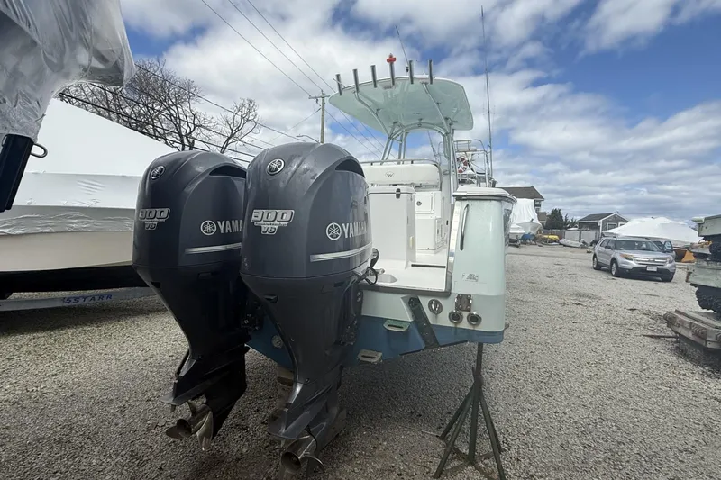 Slide: The Image of 2012 Southport 29 Tournament Edition boat with twin Yamaha 300 engines on a gravel lot. - 26