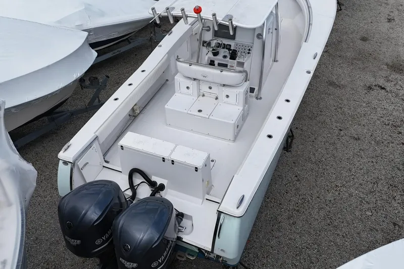 Slide: The Image of 2012 Southport 29 Tournament Edition boat with dual Yamaha engines, docked on gravel. - 6