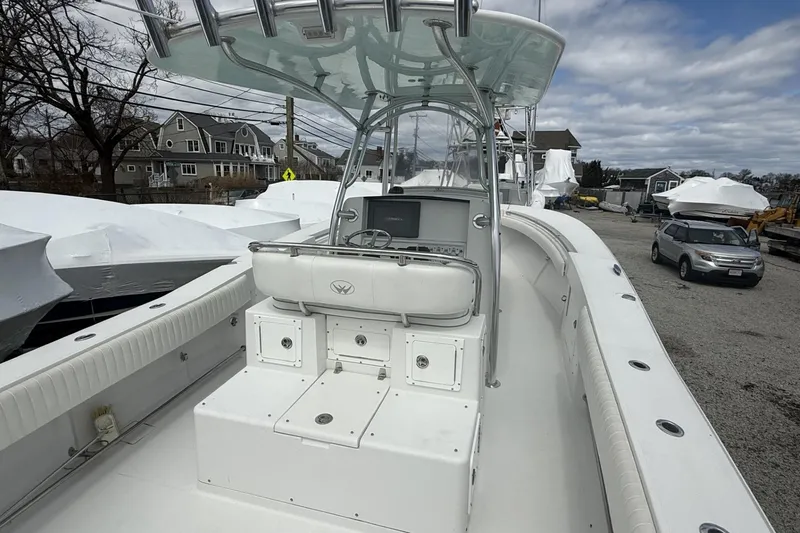 Slide: The Image of 2012 Southport 29 Tournament Edition boat with center console and T-top, docked outdoors. - 9