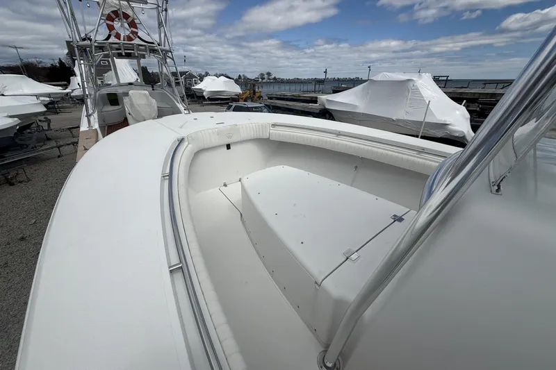 Slide: The Image of 2012 Southport 29 Tournament Edition boat docked, showcasing spacious deck and seating area. - 13