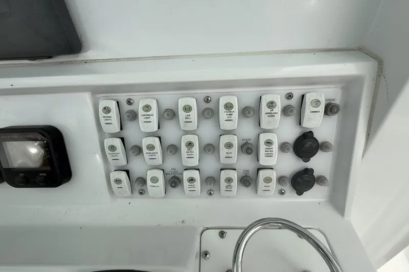 Slide: The Image of Control panel of a 2012 Southport 29 Tournament Edition boat with labeled switches. - 18