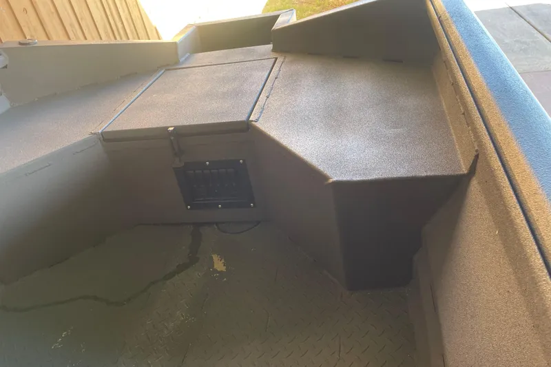 Slide: The Image of Interior view of 2026 Reaper Boats 550 Timber Reaper, showcasing storage compartment and seating area. - 14