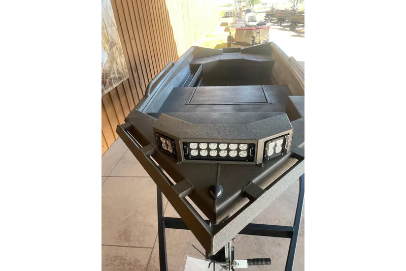 Slide: The Image of 2026 Reaper Boats 550 Timber Reaper with LED lights, displayed on a stand. - 4