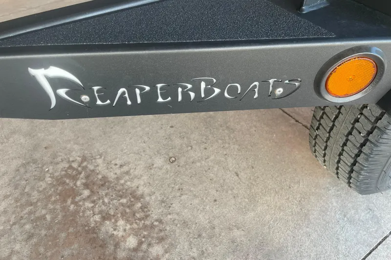 Slide: The Image of Reaper Boats 550 Timber Reaper 2026 trailer with logo and orange reflector. - 8