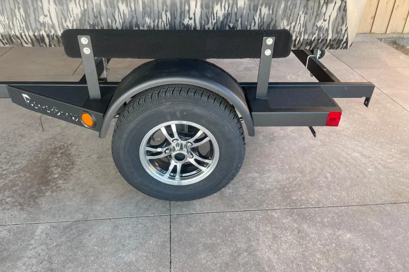 Slide: The Image of Trailer wheel of 2026 Reaper Boats 550 Timber Reaper on concrete surface. - 9