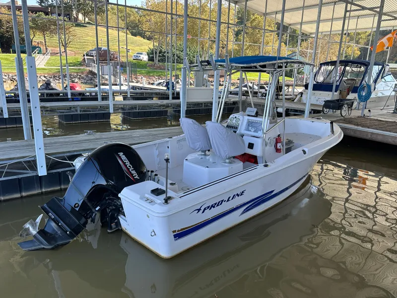 Slide: The Image of 2000 Pro-Line 20 Sport boat docked with Mercury outboard motor. - 3