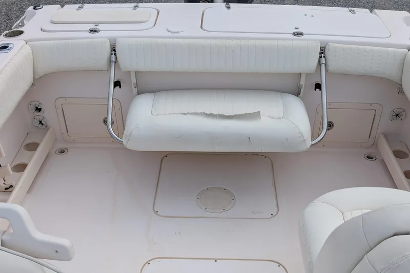 Slide: The Image of 2007 Grady-White Tournament 225 boat interior with worn seating and storage compartments. - 12