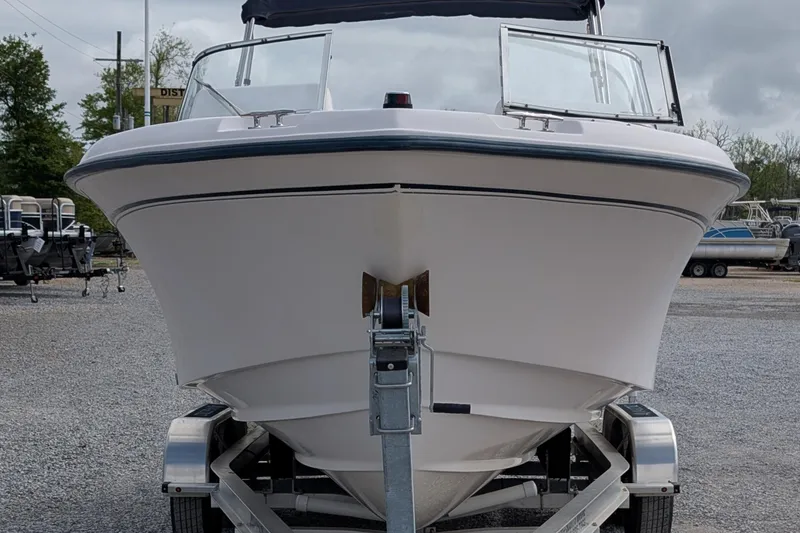 Slide: The Image of 2007 Grady-White Tournament 225 boat on trailer, front view, parked outdoors. - 2