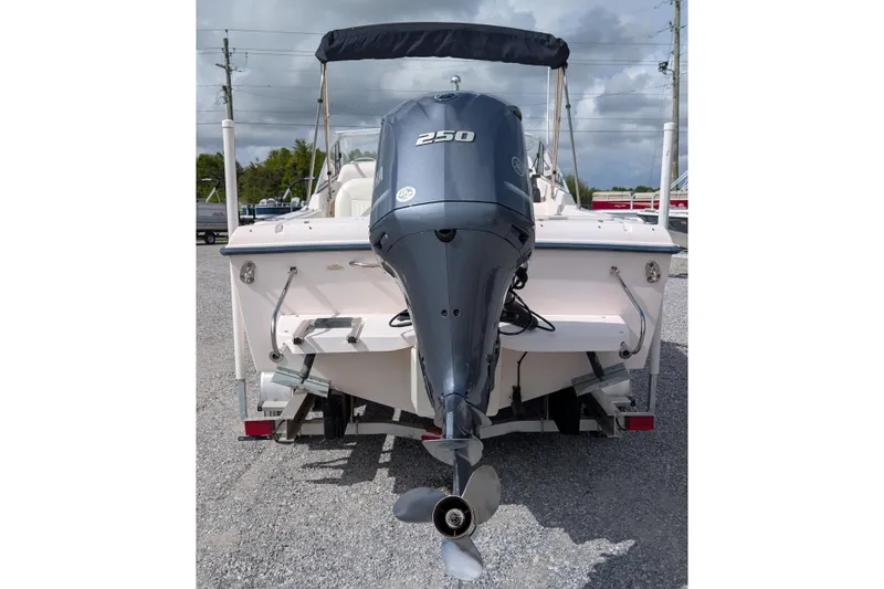 Slide: The Image of 2007 Grady-White Tournament 225 boat with powerful outboard motor, parked on gravel. - 3