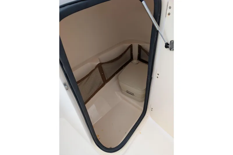 Slide: The Image of 2007 Grady-White Tournament 225 boat interior with storage compartment and portable toilet. - 9