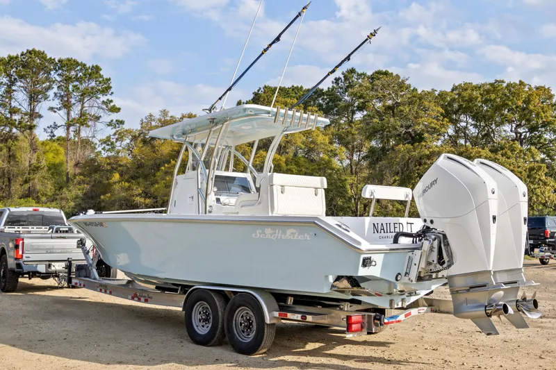 Slide: The Image of 2021 SeaHunter 28 Floridian boat on trailer with dual Mercury engines. - 11
