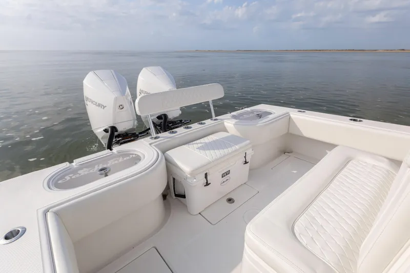 Slide: The Image of 2021 SeaHunter 28 Floridian boat interior with twin Mercury engines on calm water. - 13