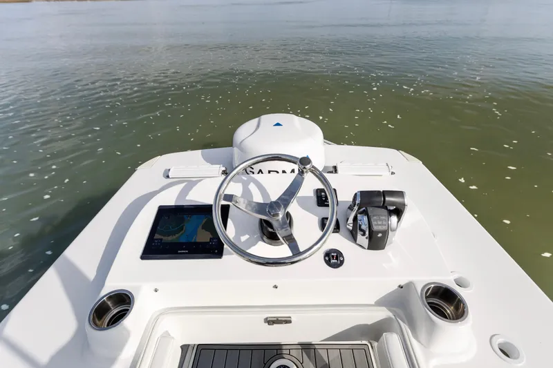 Slide: The Image of 2021 SeaHunter 28 Floridian boat helm with Garmin navigation system on calm water. - 14