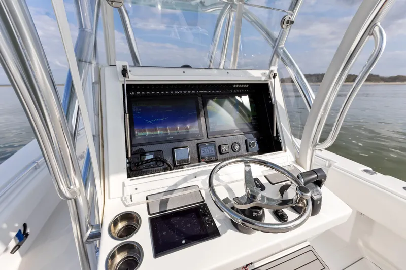 Slide: The Image of 2021 SeaHunter 28 Floridian boat dashboard with advanced navigation system and steering wheel. - 16