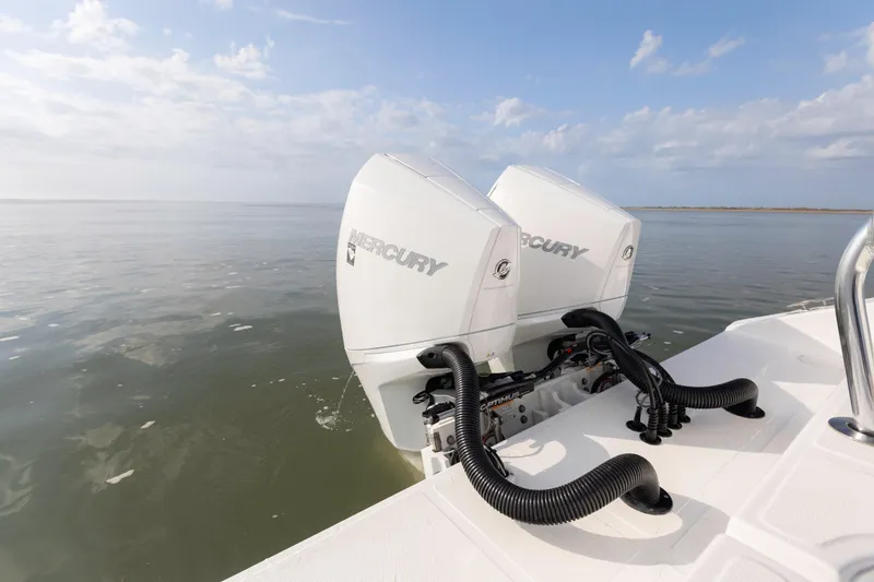 Slide: The Image of Twin Mercury outboard engines on a 2021 SeaHunter 28 Floridian boat in calm waters. - 17