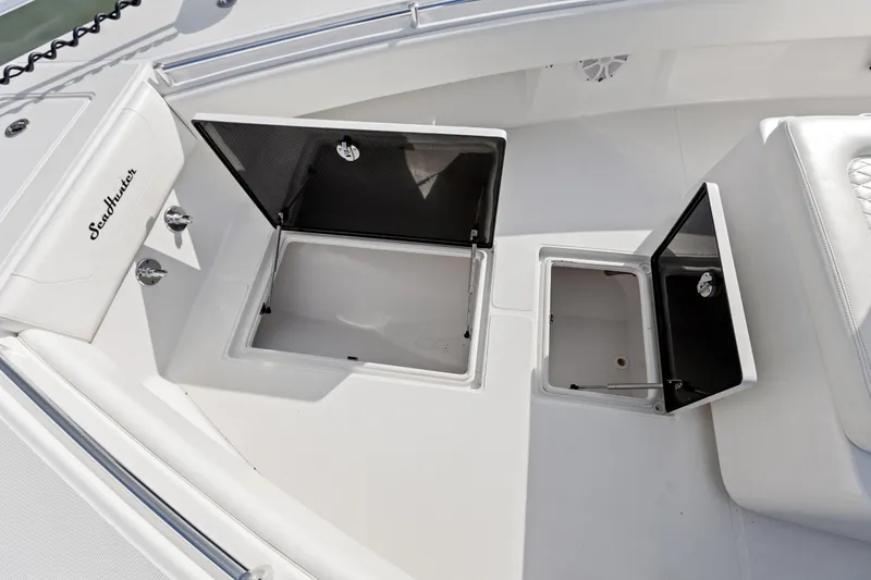 Slide: The Image of 2021 SeaHunter 28 Floridian boat deck with open storage compartments. - 20