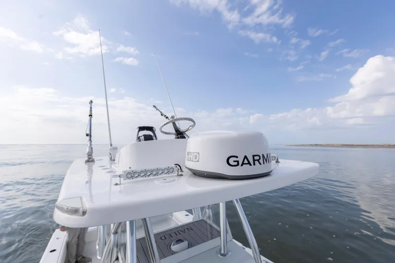 Slide: The Image of 2021 SeaHunter 28 Floridian boat with Garmin radar on calm ocean waters. - 21