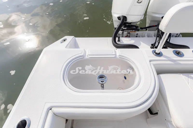 Slide: The Image of 2021 SeaHunter 28 Floridian boat deck with livewell and seating, on calm water. - 22