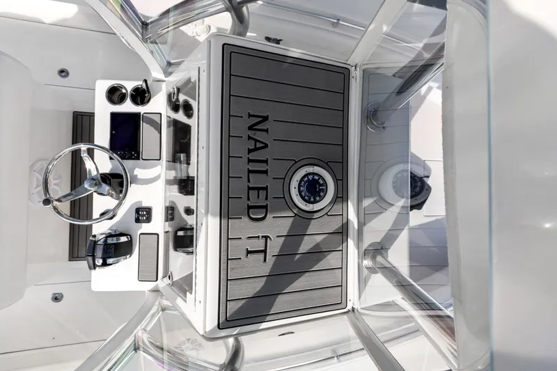 Slide: The Image of 2021 SeaHunter 28 Floridian boat console with "Nailed It" text and compass. - 23