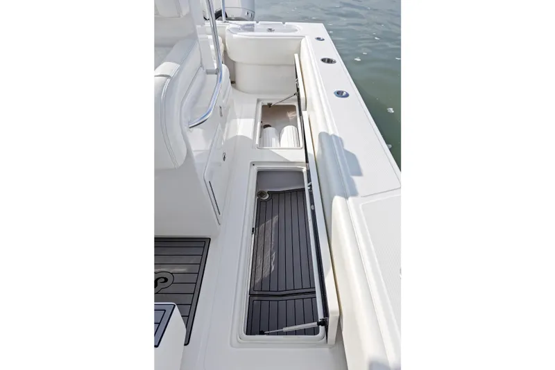 Slide: The Image of 2021 SeaHunter 28 Floridian boat interior with open storage compartments and sleek design. - 28