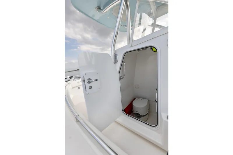 Slide: The Image of 2021 SeaHunter 28 Floridian boat with open cabin door revealing interior toilet. - 29