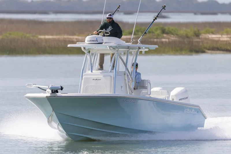 Slide: The Image of 2021 SeaHunter 28 Floridian boat cruising on water with two people onboard. - 3