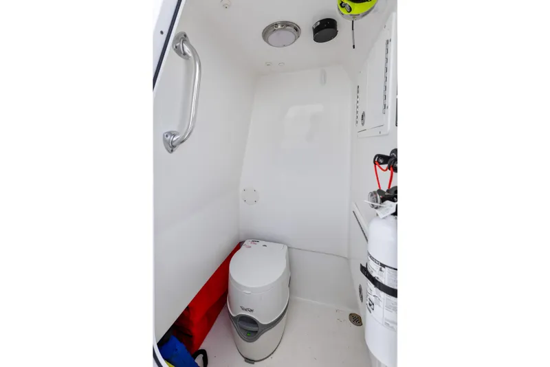 Slide: The Image of Interior of 2021 SeaHunter 28 Floridian boat featuring compact marine toilet setup. - 30