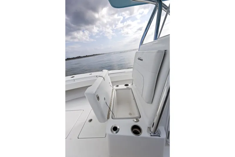 Slide: The Image of 2021 SeaHunter 28 Floridian boat interior with open storage compartment, ocean view. - 31